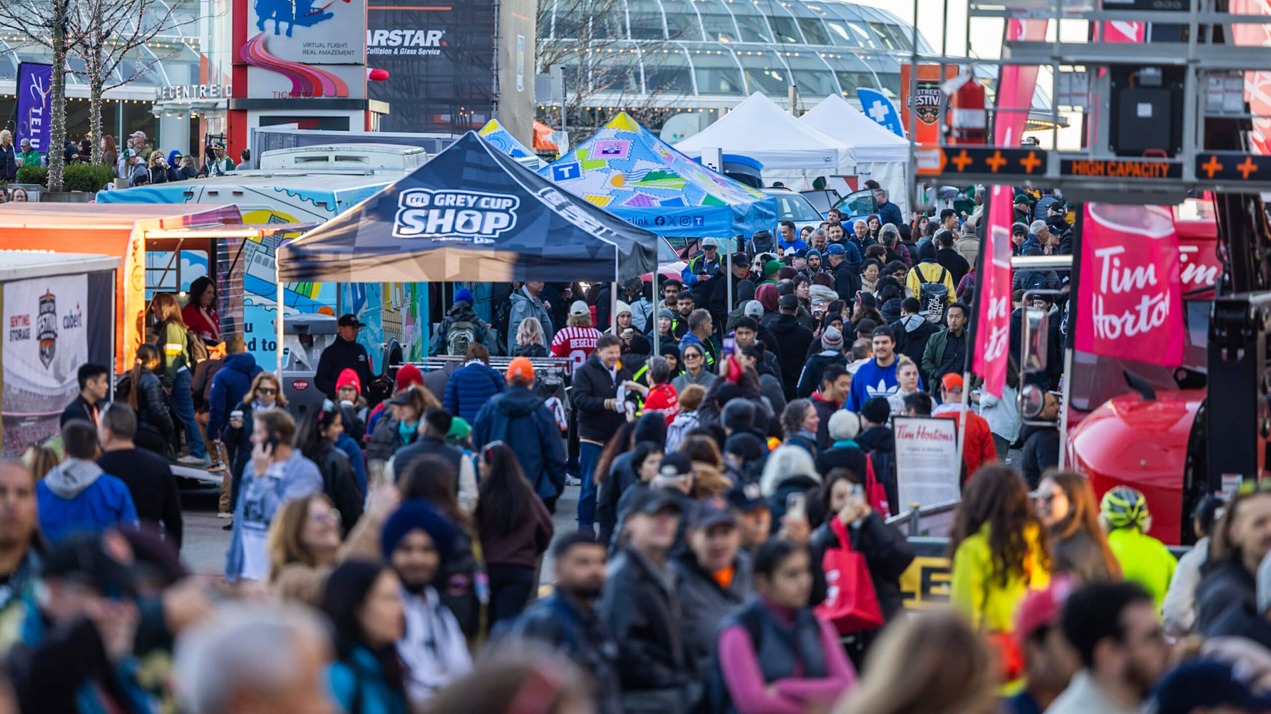 A crowd of people in the street at the 2024 Grey Cup Festival.