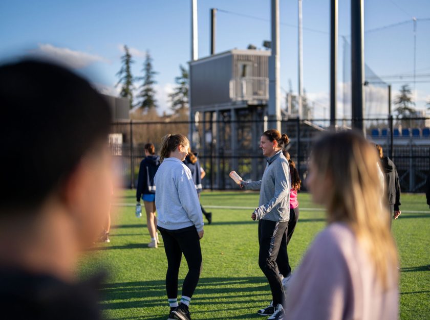 Christine Sinclair on the field, interacting with young girls in the Sinclair Soccer Summit – clicking this link will open a larger version of it in the browser window.