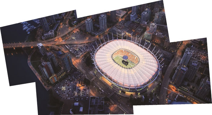 BC Place and part of downtown Vancouver from above at night.
