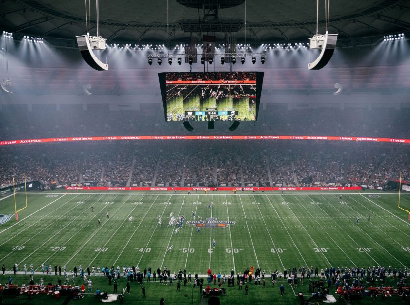 The 2024 Grey Cup as seen from the high stands. This wide shot showcases the scoreboard, the game on the field, and the stands full of attendees – clicking this link will open a larger version of it in the browser window.