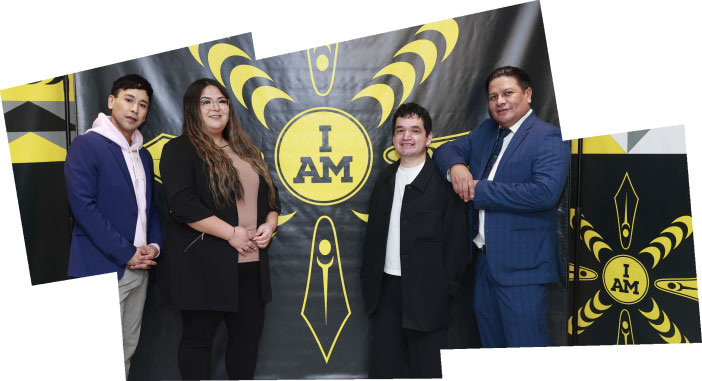 Indigenous artists stand in front of a banner displaying the 2024 Invictus Games brand that they helped design.