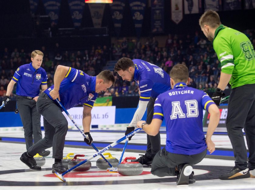 Curlers sweeping the ice in front of a stone during the 2024 Montana's Brier event – clicking this link will open a larger version of it in the browser window.