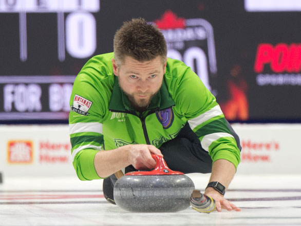 A curler throwing a stone at the 2024 Montana's Brier event.