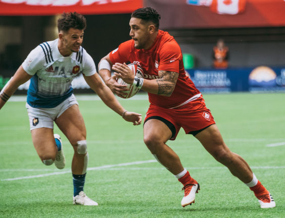 Athletes compete in a Rugby match during the 2018 Rugby Sevens.
