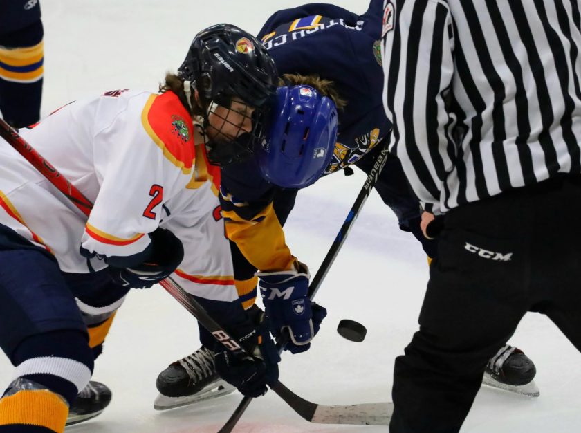 Two players fight for the puck during a puck drop at the 2024 National Aboriginal Hockey Championships – clicking this link will open a larger version of it in the browser window.