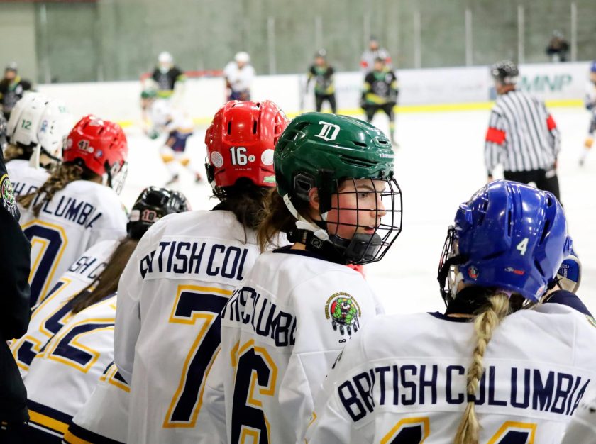 Players look onto the ice from the bench during a Women's game at the 2024 National Aboriginal Hockey Championships – clicking this link will open a larger version of it in the browser window.