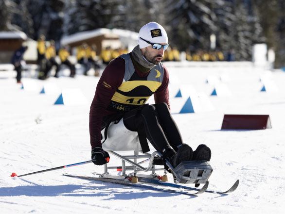 A man on adaptive ski equipment participating in an Invictus Games nordic event.